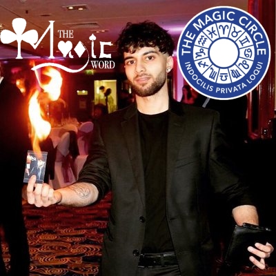 Magician The Magic Word Holding A Business Card On Fire At Corporate Event
